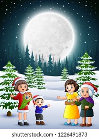 Happy family in the snowy garden at night
