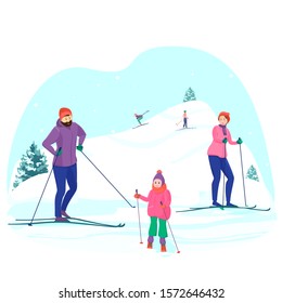 Happy family spends a weekend in the country. Mom, dad and daughter go cross-country skiing and downhill. Winter sports in the fresh air.