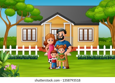 Happy family standing in front of the house