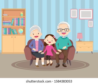 Happy family whith grandchildrens and grandparents sitting on the sofa.