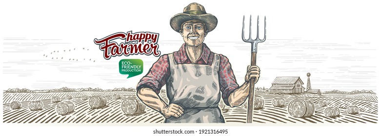 Happy farmer with a pitchfork in his hands, against the background of an agricultural landscape.