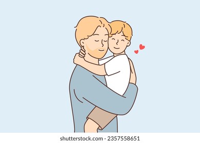 Happy father holds and hugs little son after long separation or returning from vacation. Caring father feels joy of fatherhood and enjoys time spent with son, who misses dad on business trip