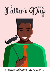 Happy Father's Day. Modern postcard with a young African American man in a tie, who, for humor, holds a paper mustache in his hand, who became a father. Vertical pink background. Vector.