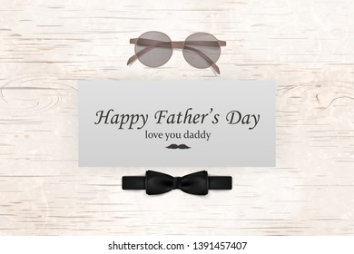 Happy Fathers Day template greeting card. Fathers day Banner, flyer, invitation, congratulation or poster design. Father's day concept. Design with black bow tie, glasses on wooden background.