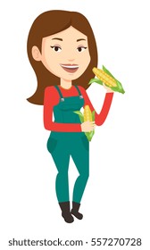 Happy female farmer holding a corn cob. Smiling caucasian female farmer collecting corn. Female farmer standing with a corn cob in hands. Vector flat design illustration isolated on white background.