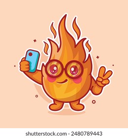 happy fire flame character mascot taking a selfie with a smartphone isolated cartoon