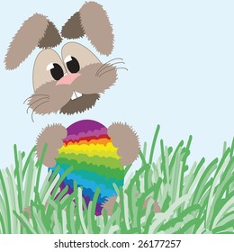happy fluffy easter bunny holding an colorful easter egg in rainbow colors