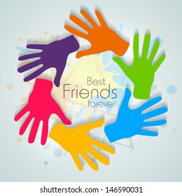 Happy friendship day concept with colorful hands print on abstract background.