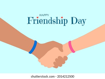 Happy Friendship Day concept. The hands of two friends as they hold each other. Blue and pink wristband that symbolize eternal friendship. Inscription with red heart decoration.