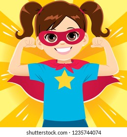 Happy funny and cute little super hero girl flexing arms showing strength