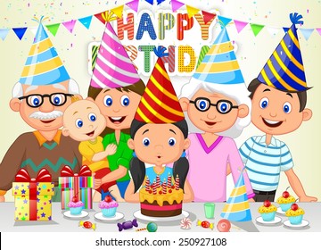 Happy girl blowing birthday candles with her family