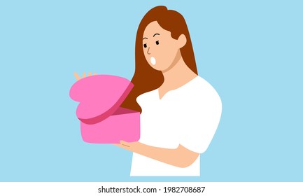 Happy girl holding a gift in her hands. Gets a gift or presents a gift box. Holiday concept birthday, christmas, valentines day