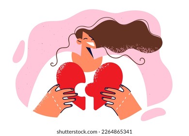 Happy girl holding heart shaped puzzle and smiling broadly while doing pandering loving people or arranging romantic date. Positive woman with heart symbolizing health care volunteering and donation 