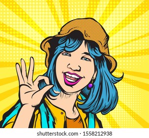 The happy girl raises her hand and shows OK.Pop art retro vector illustration vintage kitsch