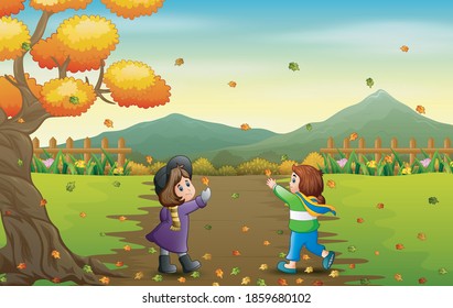 Happy girls catching falling leaf in autumn landscape