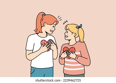 Happy girls kids holding paper heart in hands showing love and care. Smiling children with postcards demonstrate support and comfort feel grateful. Vector illustration. 