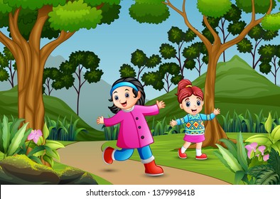 Happy girls walking at the forest path