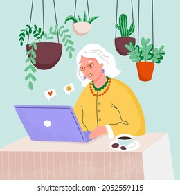 Happy grandmother with the laptop computer at home. Old woman online working.