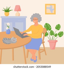 Happy grandmother with a laptop is sitting in the living room. Сozy interior with potted plants and a sleeping cat. Elderly people use technology, computers.