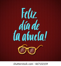 Happy Grandparents Day Spanish Calligraphy Greeting Card on Brown Knitted Background with Glasses.