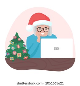 Happy granny with Christmas hat looking at laptop. Old woman with glasses speaking online. Holiday communication with family.