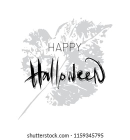 Happy halloween. Black and white calligraphy. Vector lettering with leaf stamp