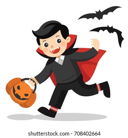 Happy Halloween. Funny little children in Dracula costume with pumpkin basket for Trick or Treat on white background.