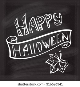 Happy Halloween hand lettering on a chalkboard background.