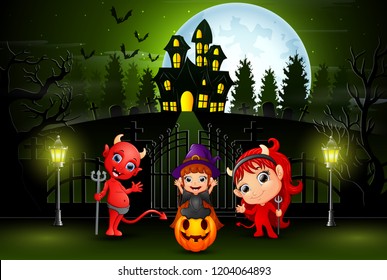 Happy halloween kids outdoors with haunted house background