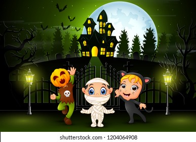 Happy halloween kids outdoors with haunted house background