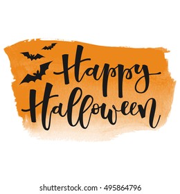 Happy halloween white hand lettering greeting with bats on orange watercolor banner background