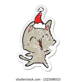 happy hand drawn distressed sticker cartoon of a cat wearing santa hat