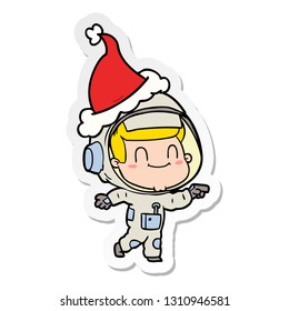 happy hand drawn sticker cartoon of a astronaut man wearing santa hat