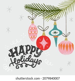 Happy Holidays inscription with Christmas baubles hanging on fir tree. Handdrawn lettering phrase for greeting card, festive banner, seasonal decor. Congratulation saying written with ornate letters