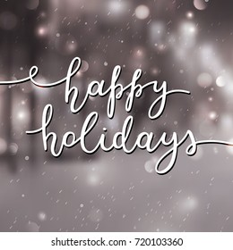 happy holidays lettering, vector handwritten text on blurred background of winter street