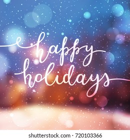 happy holidays lettering, vector handwritten text on blurred background of winter street