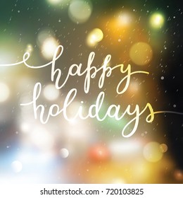 happy holidays lettering, vector handwritten text on blurred background of lights