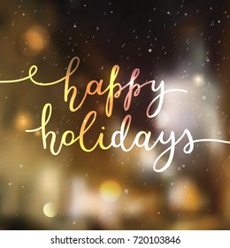 happy holidays lettering, vector handwritten text on blurred background of winter street