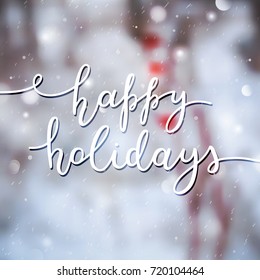 happy holidays lettering, vector handwritten text on blurred background of dog-rose