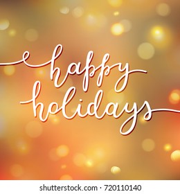 happy holidays lettering, vector handwritten text on blurred background of lights