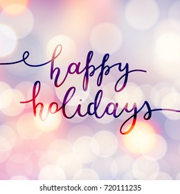 happy holidays lettering, vector handwritten text on blurred background of lights