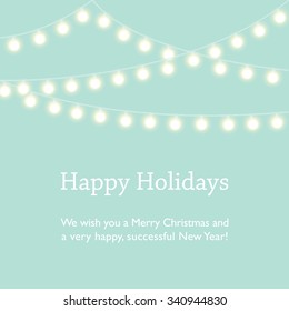 Happy Holidays, Merry Christmas and Happy New Year wishes. Mint green background with fairy lights.