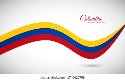 Happy independence day of Colombia. Artistic shiny wavy Colombia flag background with text typography.