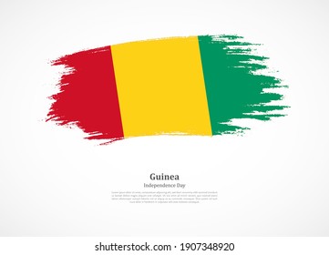 Feliz día de la independencia de Guinea con bandera nacional en textura gruesa