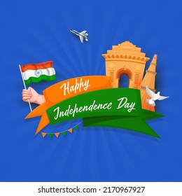 Happy Independence Day Ribbon Text With India Gate, Qutub Minar Monument, Hand Holding India Flag, Pigeon, Fighter Jet On Blue Rays Background. 