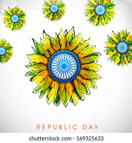 Happy Indian Republic Day concept with beautiful floral design decorated with peacock feathers and Ashoka Wheel on grey background. 