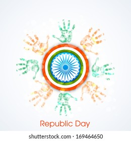Happy Indian Republic Day concept with human hands in national flag colors and Ashoka Wheel on blue background. 