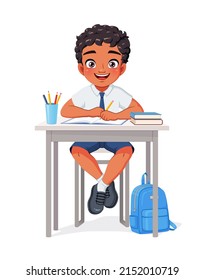 Happy Indian school boy sitting at desk studying. Cartoon vector illustration isolated on white background.