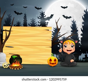 Happy kid wearing cat costume sitting beside the wooden board