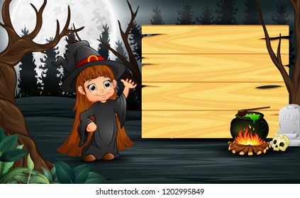 Happy kid wearing witch costume stand beside the wooden board